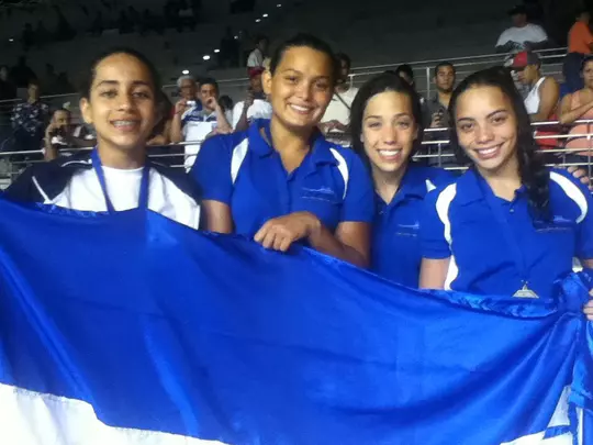 Julimar Avila holding a Honduras flag with teammates