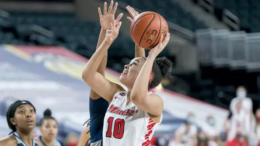 Caitlin Weimar going up for a layup with a defender behind her