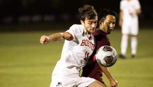Brian Hernandez battles a UMass player for the soccer ball as it bounces right in front of them.