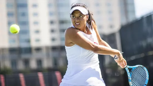 Steph Nguyen holds the backhand back with the racquet as the tennis ball approaches her.