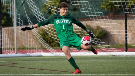 Michael Stone boots the soccer ball after dropping it on the ground while in the goalie box.