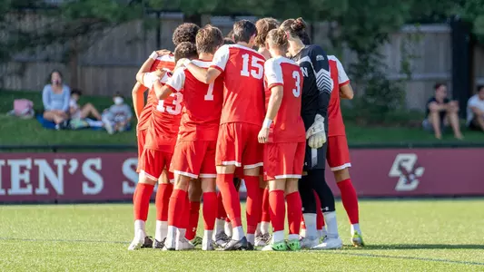 Boston University men's soccer team starting lineup huddles