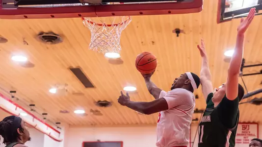 Walter Whyte goes for a layup attempt at home with a Loyola defender behind him.