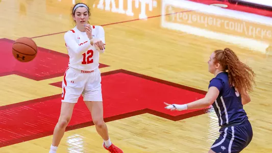 Annabelle Larnard passes the ball from outside the arc.