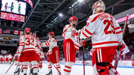 The Terriers, including Jay O'Brien and Drew Commesso, celebrate after BU defeated Vermont, 4-0