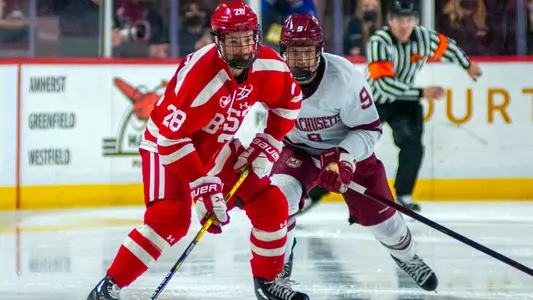 Ethan Phillips skates in front of a UMass player