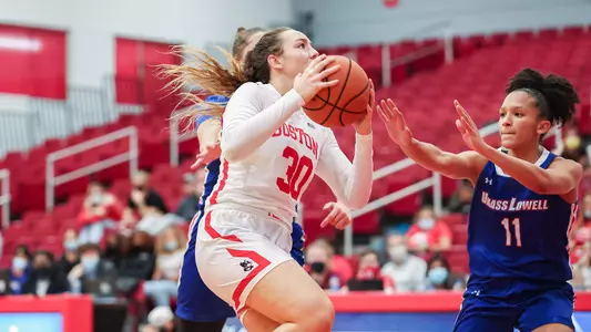 Lauren Davenport goes up for a layup with two UMass Lowell defenders nearby.