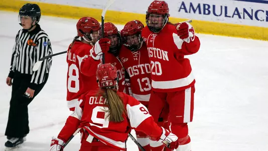 The women's ice hockey team celebrates a goal