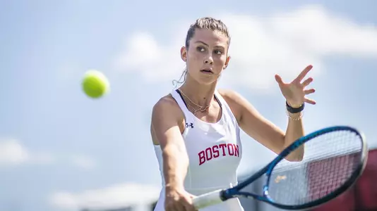 Side angle view of Michelle Kleynerman hitting a volley