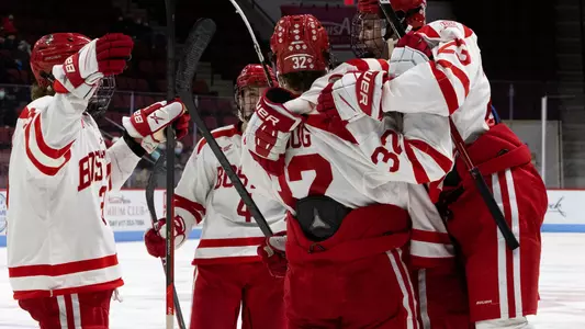 The men's ice hockey team celebrates a goal