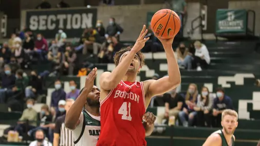 Sukhmail Mathon attempts a layup with a Dartmouth defender behind him.