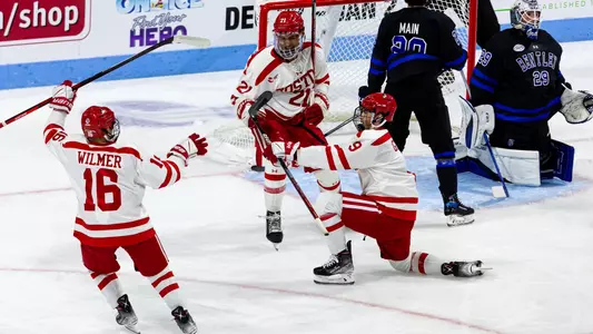 Jeremy Wilmer, Devin Kaplan and Ryan Greene celebrate a goal in the BU men's ice hockey team's win over Bentley