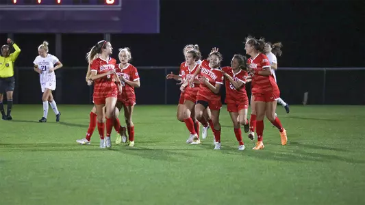 Photo of the women's soccer team celebrating Jenna Oldham's goal against Holy Cross.