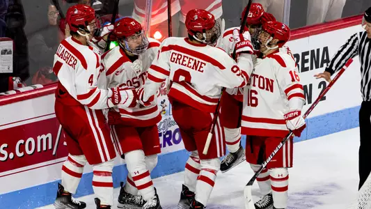 The men's ice hockey team celebrates a goal