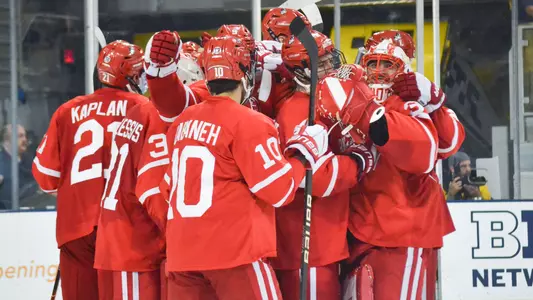 The men's hockey team celebrates a win