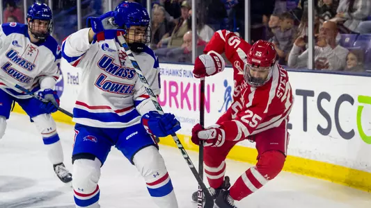 Sam Stevens battles a UMass Lowell player for the puck