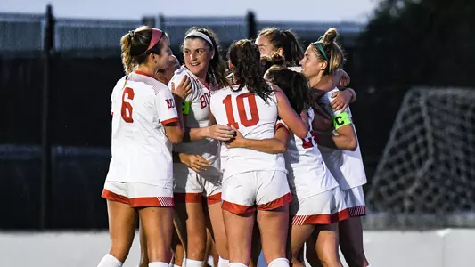 Photo of the women's soccer team after celebrating a goal against Providence.