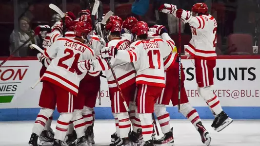 The men's ice hockey team celebrates an overtime win