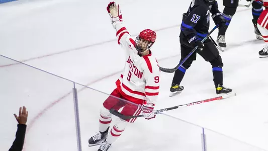 Ryan Greene of the men's ice hockey team celebrates one of his two goals against Bentley