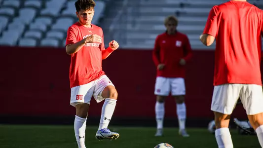 Matthew Boberg kicks a ball during pregame warmup drill.