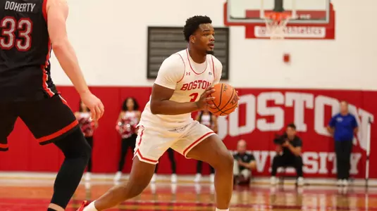 Malcolm Chimezie pivots his foot to make a chest pass to the side.