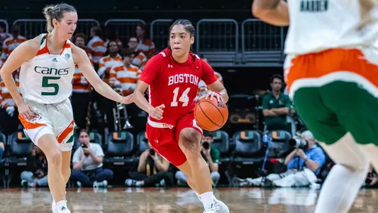 Photo of women's basketball senior Sydney Johnson driving against a Miami defender.