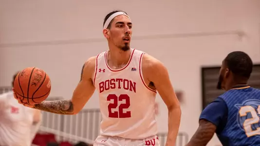 Anthony Morales handles the ball with a Johnson & Wales player guarding him.