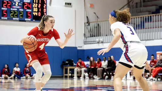 Photo of women's basketball senior Liz Shean dribbling up the court at UMass Lowell.
