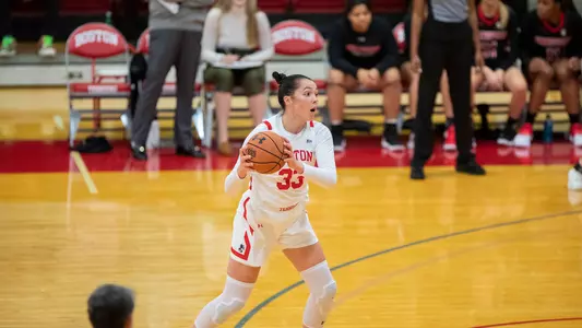Photo of women's basketball senior Maren Durant looking to pass the ball against Hartford.