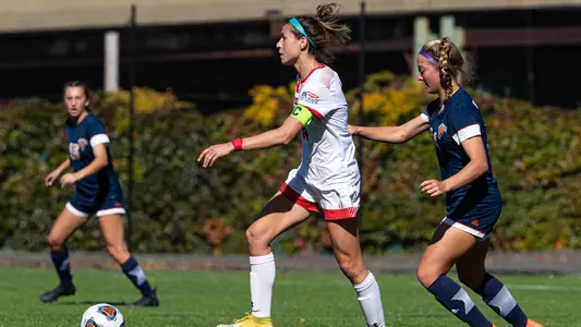 Photo of women's soccer redshirt senior Amy Thompson dribbling the ball against Bucknell.