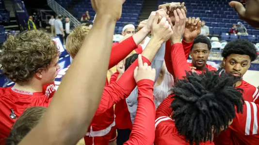 BU men's basketball team huddles at UConn before tip-off.