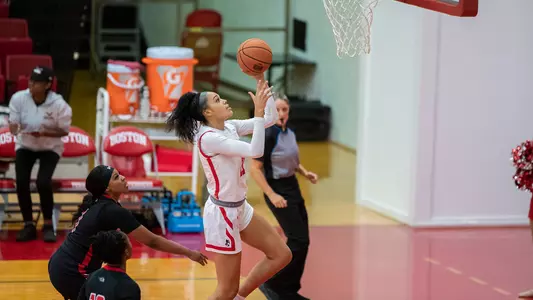 Photo of women's basketball junior Caitlin Weimar going for a layup against Hartford.