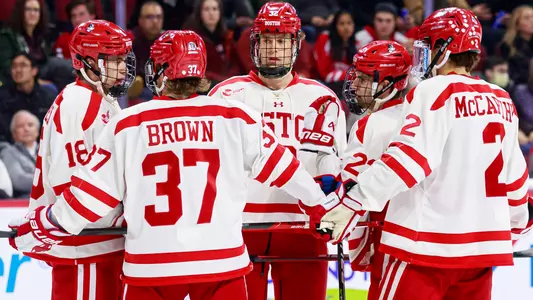 Jay O'Brien, Matt Brown, Wilmer Skoog, Domenick Fensore and Case McCarthy discuss something on the ice during a hockey game
