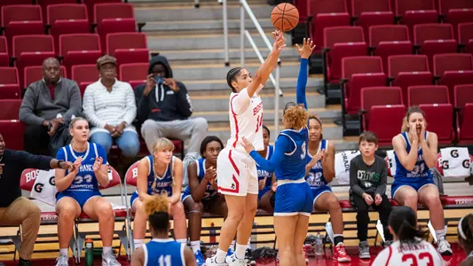 Photo of women's basketball senior Sydney Johnson attempting a three-pointer against St. Francis Brooklyn.