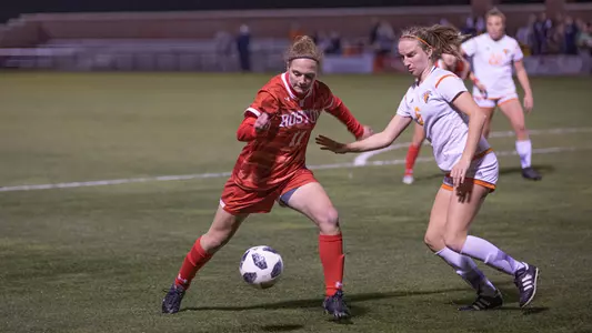 Photo of women's soccer sophomore Erin Sullenberger collecting the ball against a Bucknell defender.