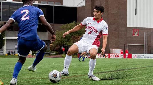 Diego Rived stretches leg out to gain control of the soccer with American player trying to grab possession.