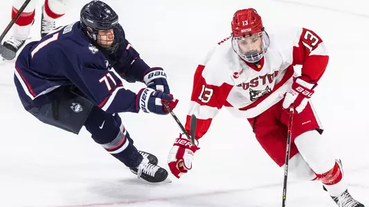 Dylan Peterson skates past a UConn player