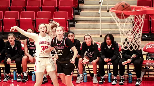 Photo of women's basketball sophomore Lauren Davenport nailing a left-wing three-pointer against Harvard.