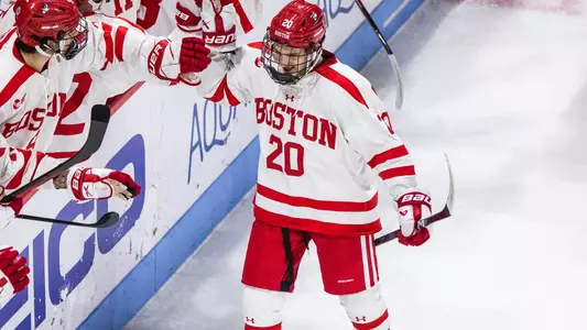 Lane Hutson celebrates a goal as he skates by his bench