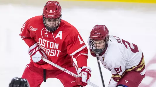 Luke Tuch next to a BC player during a faceoff
