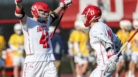 Jake Cates and Vince D'Alto of the men's lacrosse team celebrate a goal