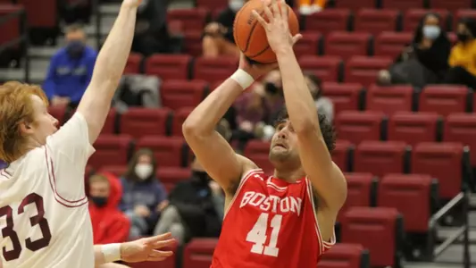 Mathon attempts a fadaway jumper with a defender sticking hand in his face.