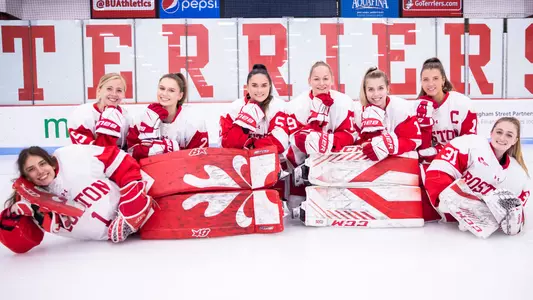 The women's ice hockey senior class poses for a picture on the ice
