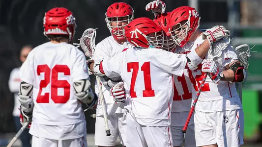 The men's lacrosse team celebrates a goal
