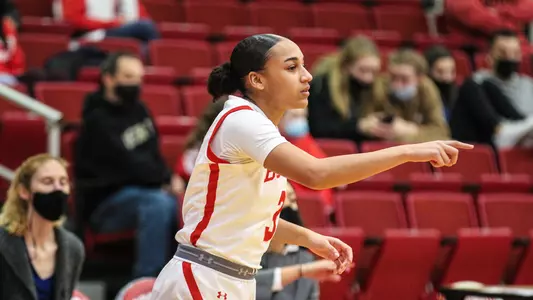 Kelsi Mingo points to a play while standing outside the arc.