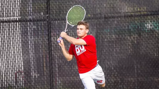 Ben Letzer hits a leaping backhand shot on one leg
