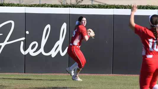 Lauren Keleher gets ready to throw a ball in the outfield toward the infield.