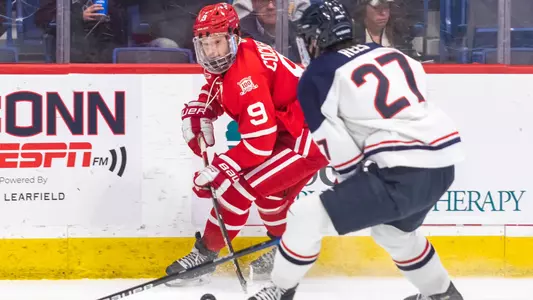 Logan Cockerill playing hockey at UConn