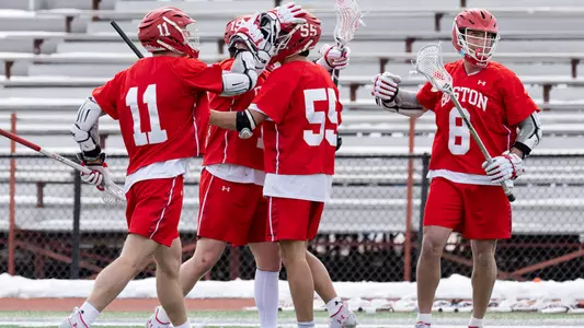 The men's lacrosse team celebrates a goal