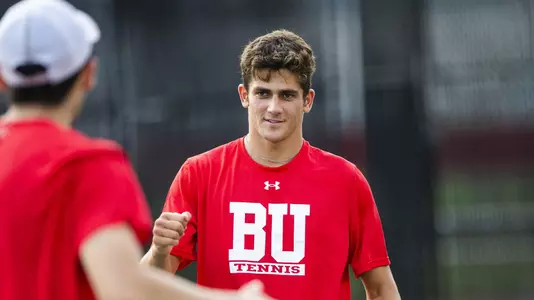 Jonah Dickson heads to his doubles partner for a high five.